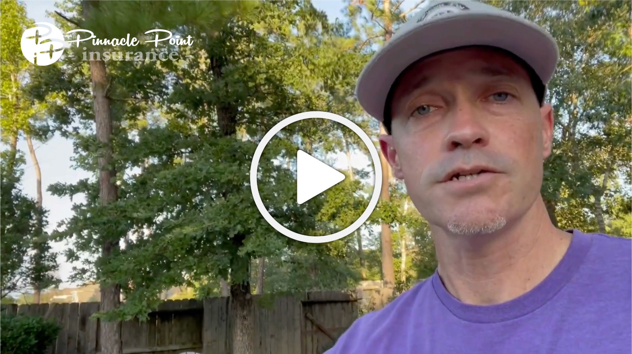 Man in a purple shirt and a gray hat discussing Hurricane Beryl food spoilage insurance outdoors, with trees and a wooden fence in the background.